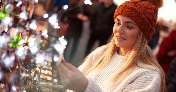 Woman admiring gifts at Durham Christmas Festival market